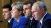 Talking about talking peace:  Ukraine's President Volodymyr Zelenskiy, German Chancellor Angela Merkel, French President Emmanuel Macron, and Russia's President Vladimir Putin attend a press conference after their December 9 summit. 