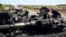 Ukraine -- A destroyed tank is seen on the road to Ilovaisk, 50 kms east of Donetsk on September 3, 2014.