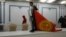 A protester carries the Kyrgyz flag inside a seized government building in Bishkek on October 6, 2020.
