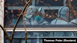 Эксперты ВОЗ во время визита в Ухань. 2 февраля 2021 года. Фото: Reuters