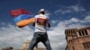 ARMENIA -- A man waves an Armenian flag at the Republic Square in Yerevan, Tuesday, May 8, 2018.