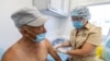 A Russian medical worker, right, administers a shot of Russia's Sputnik V coronavirus vaccine on June 18, 2021 in a mobile vaccination center on Sakhalin Island.