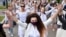 Women dressed in white clothes in Minsk, Belarus on August 12, 2020 protest against police violence during recent rallies against suspected election fraud. 