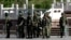 China -- Chinese paramilitary policemen stand guard on a city square in Urumqi in China's Xinjiang region on May 24, 2014. China has seen a series of incidents in recent months targeting civilians, sometimes far from Xinjiang itself, which authorities ha
