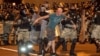 Minsk, Belarus - Law enforcement officers escort a man during clashes with opposition supporters after poll closed at presidential election